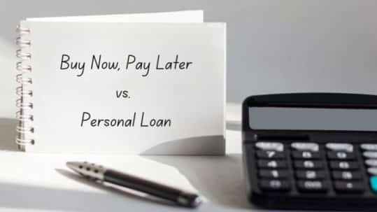 Words "Buy Now Pay Later vs. Personal Loan" on a notebook with a pen and calculator on a table